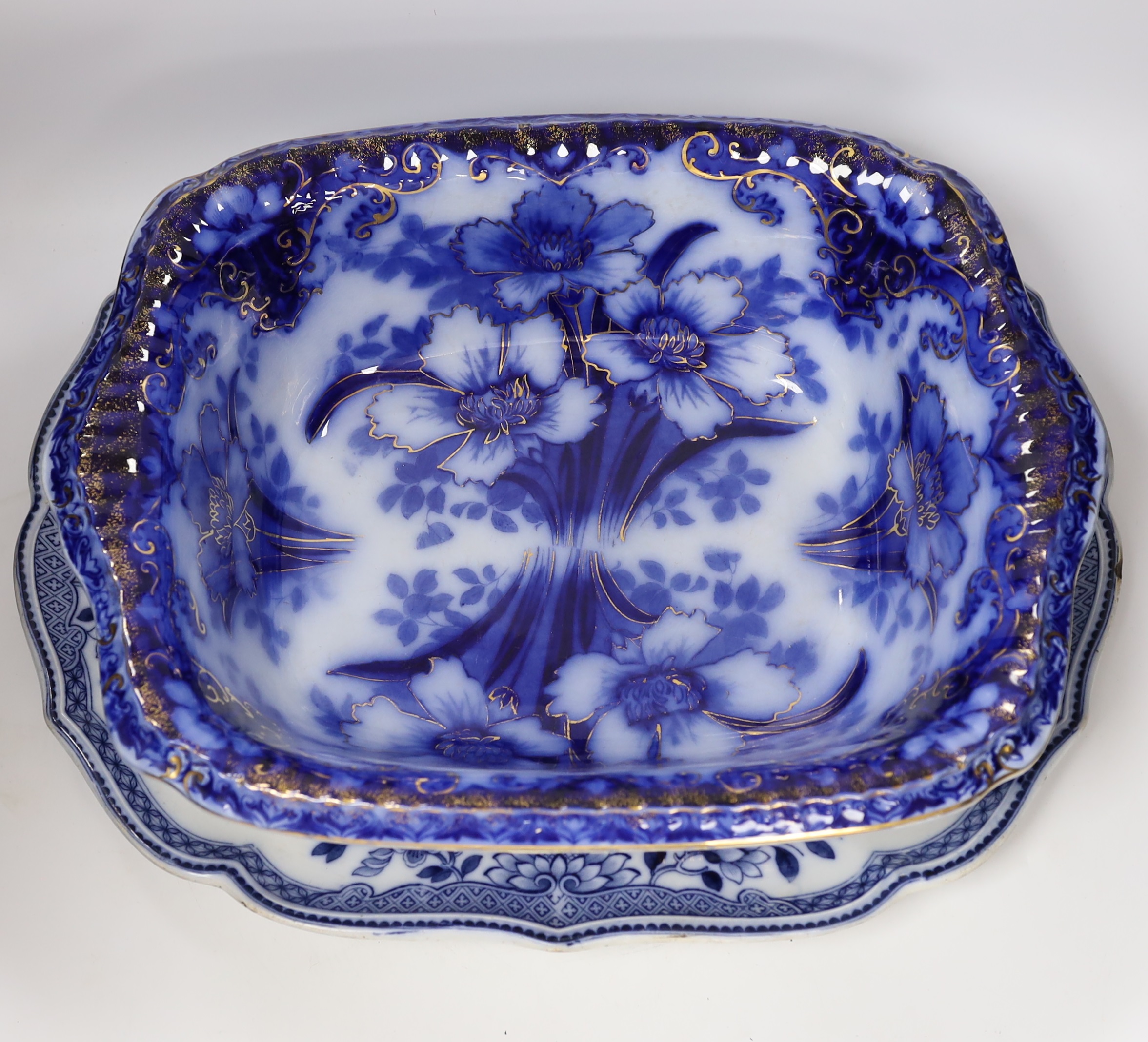 A Flow blue and gilt decorated bowl, a blue and white meat platter, a Royal Doulton vase, a gilt Egyptian inspired centrepiece and a set of six gilt bordered plates
